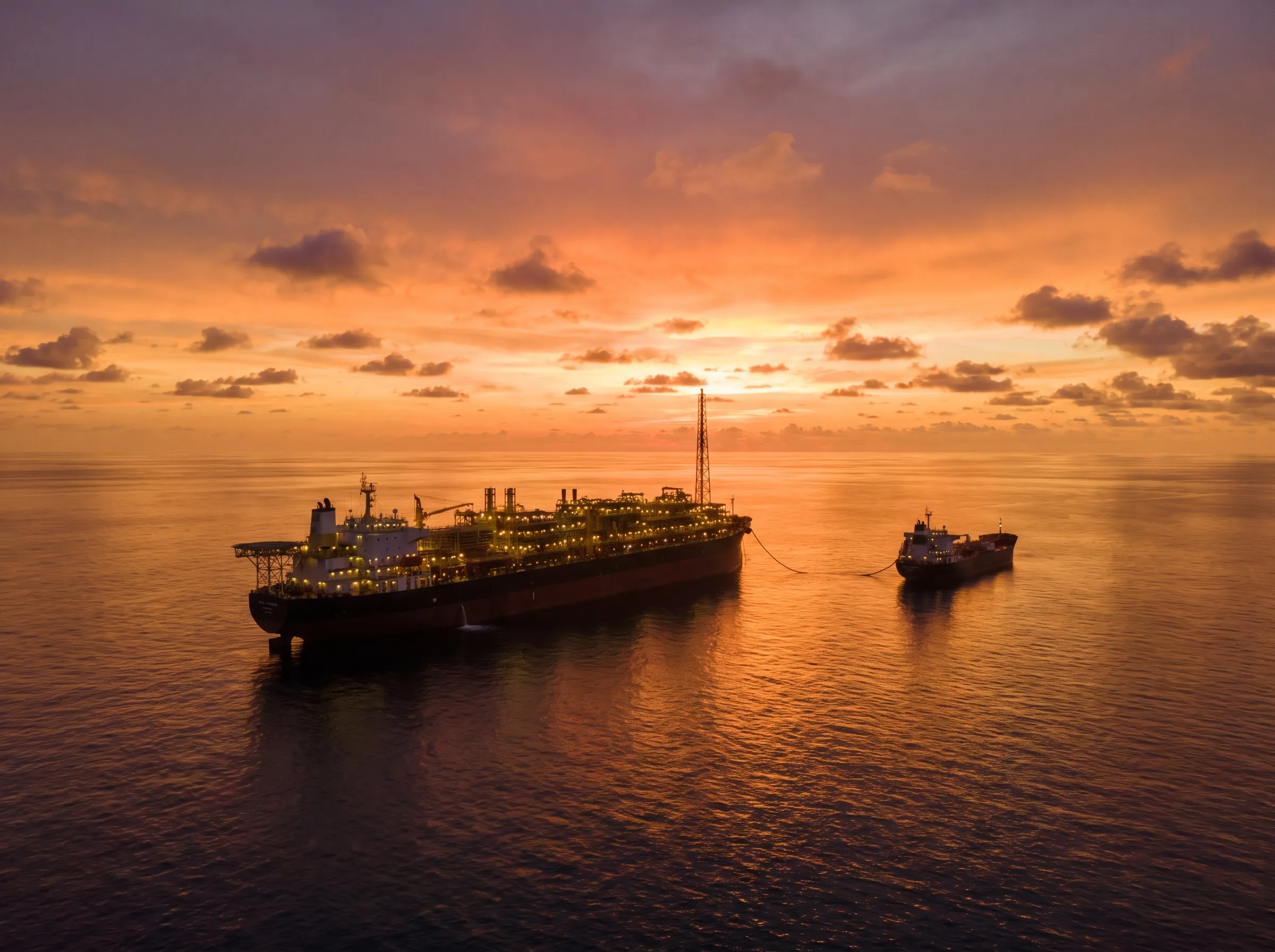 A floating production vessel offshore West Africa at sunset